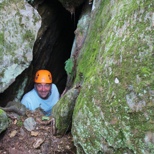 senior guest doing rock challenge squeeze at high rock adventures, hocking hills ohio