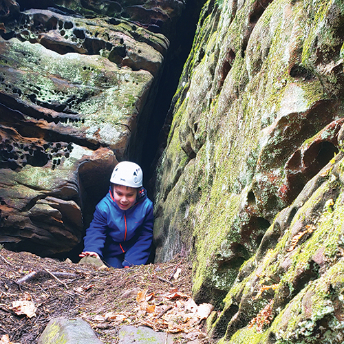 children going through rock squeeze at high rock adventures, hocking hills Ohio
